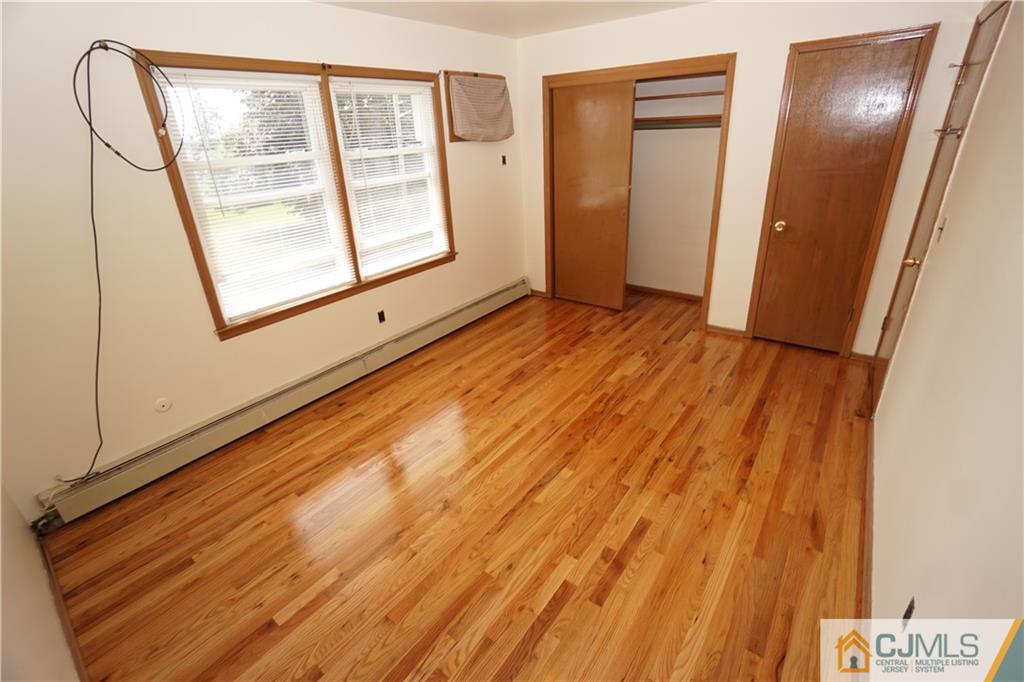 400 Washington Avenue Linden, NJ 07036 - Photo 11 of 18 a view of an empty room with wooden floor and a window