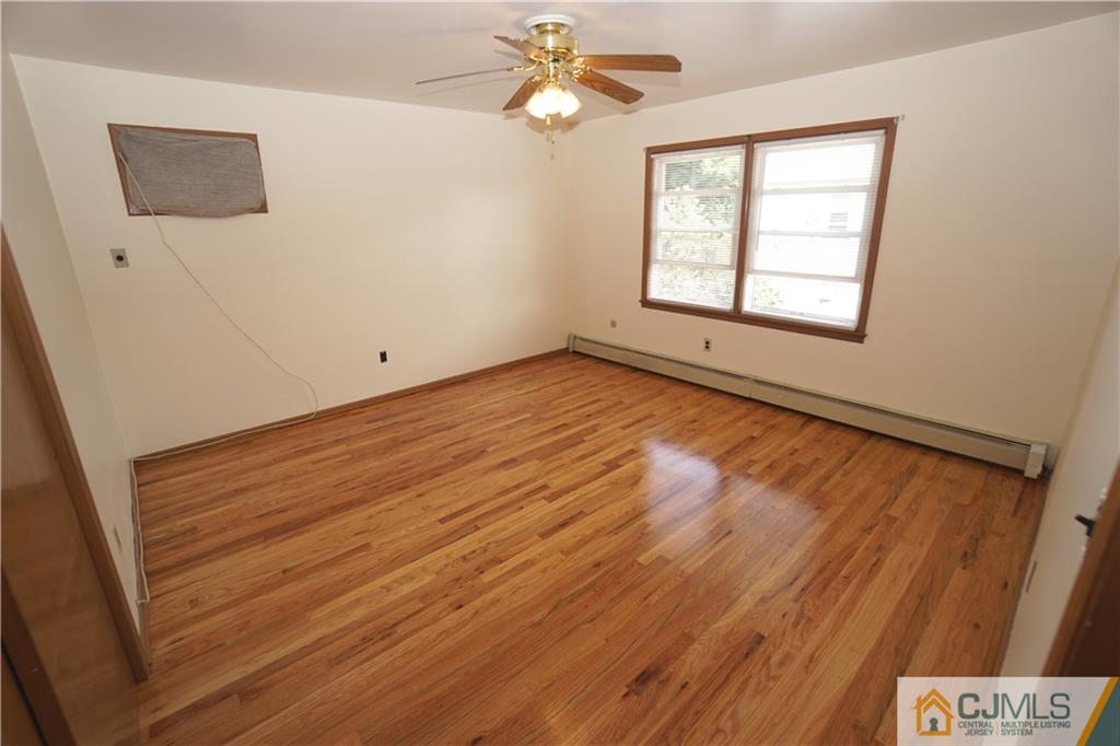 400 Washington Avenue Linden, NJ 07036 - Photo 12 of 18 a view of an empty room with a window and wooden floor