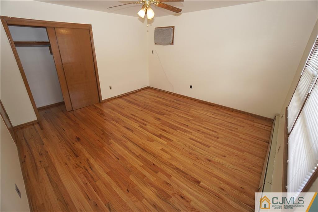 400 Washington Avenue Linden, NJ 07036 - Photo 13 of 18 an empty room with wooden floor and fan