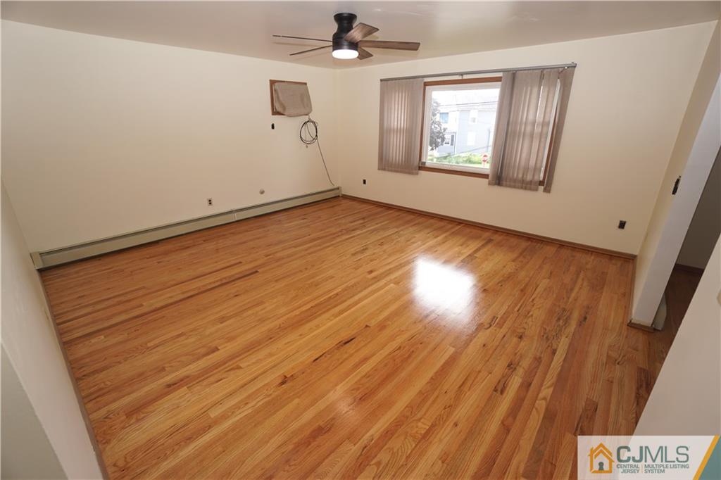 400 Washington Avenue Linden, NJ 07036 - Photo 4 of 18 a view of empty room with wooden floor and fan