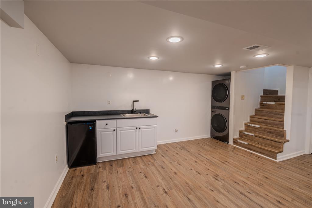 12324 Centerhill Street Silver Spring, MD 20902 - Photo 17 of 24 a view of an empty room with wooden floor and stairs