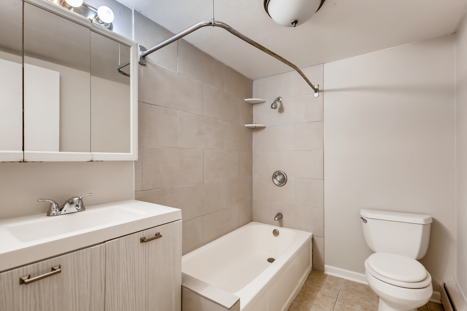 2206 South Goebbert Road, Unit 409 Arlington Heights, IL 60005 - Photo 8 of 10 a bathroom with a sink a toilet and shower