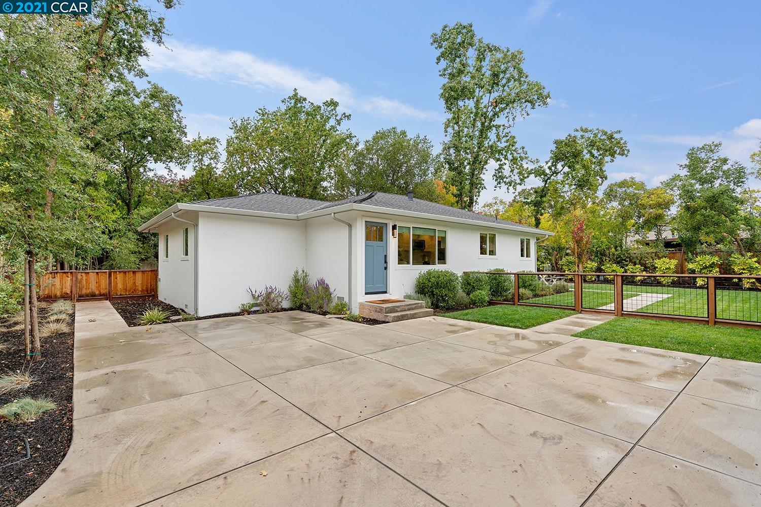 a view of a house with backyard and a garden