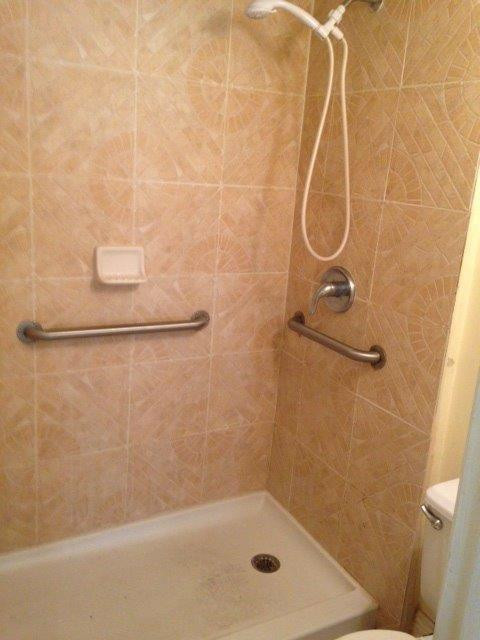 4221 West McNab Road, Unit 29 Pompano Beach, FL 33069 - Photo 11 of 15 a bathroom with a bath tub with a shower