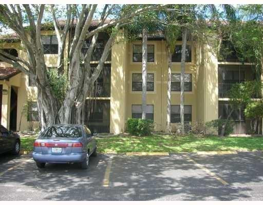 4221 West McNab Road, Unit 29 Pompano Beach, FL 33069 - Photo 2 of 15 a view of a brick house with a yard