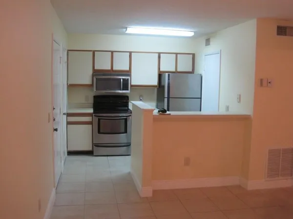 a kitchen with stainless steel appliances a refrigerator and a stove