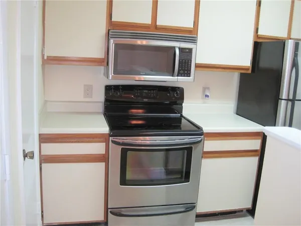 a stove top oven sitting inside of a kitchen