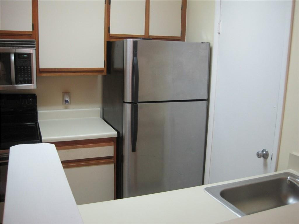 4221 West McNab Road, Unit 29 Pompano Beach, FL 33069 - Photo 6 of 15 a white refrigerator freezer and a stove sitting inside of a kitchen