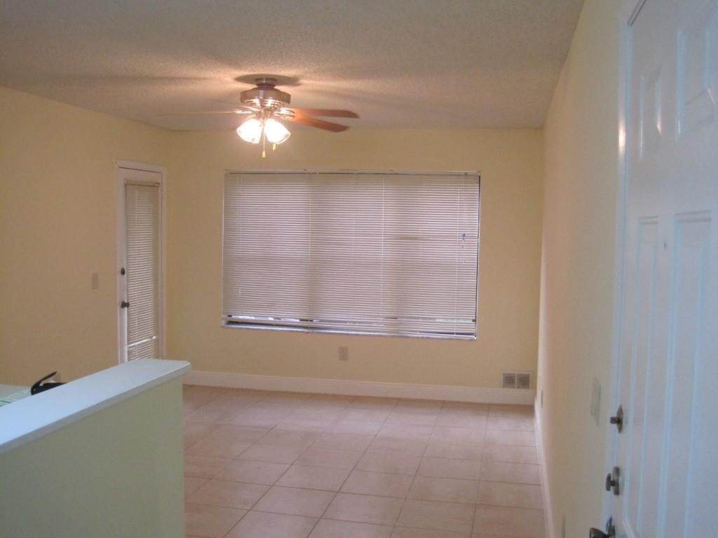 4221 West McNab Road, Unit 29 Pompano Beach, FL 33069 - Photo 9 of 15 a view of a livingroom with a ceiling fan and window