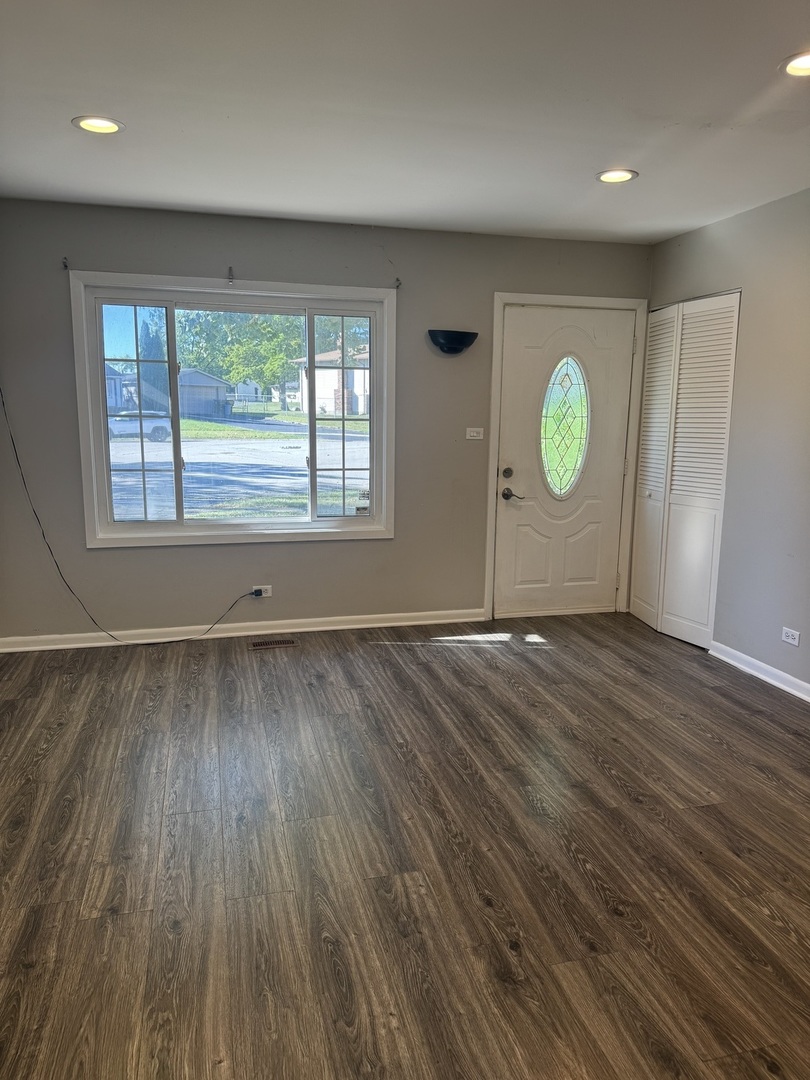 3614 Wheelwood Court Hazel Crest, IL 60429 - Photo 2 of 9 an empty room with wooden floor and window