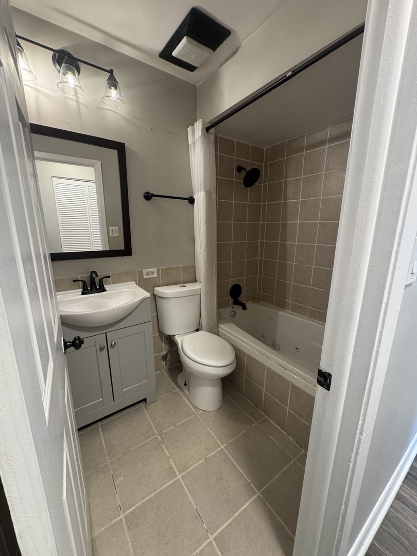 3614 Wheelwood Court Hazel Crest, IL 60429 - Photo 6 of 9 a bathroom with a toilet a sink a mirror and shower