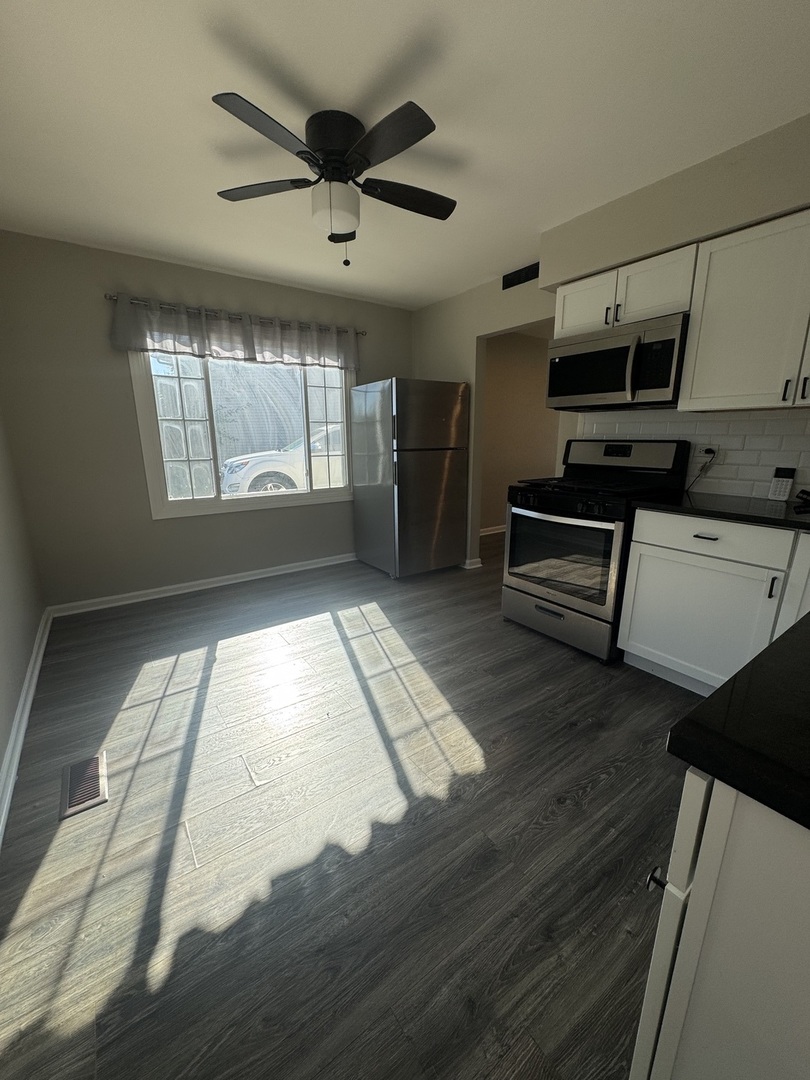 3614 Wheelwood Court Hazel Crest, IL 60429 - Photo 9 of 9 a living room with stainless steel appliances kitchen island granite countertop a stove a refrigerator and a cabinets