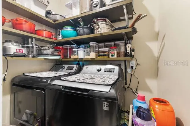 a living room with furniture a window and a flat screen tv