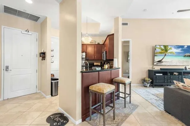 a living room with furniture and a chandelier