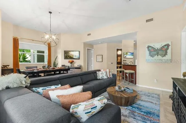 a large bedroom with a bed and flat screen tv