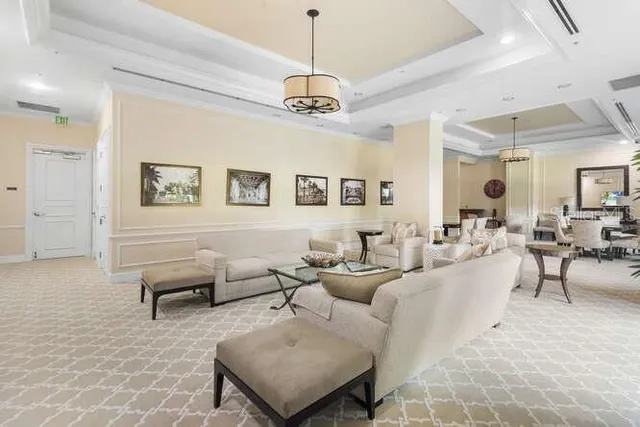 a living room with furniture and a chandelier