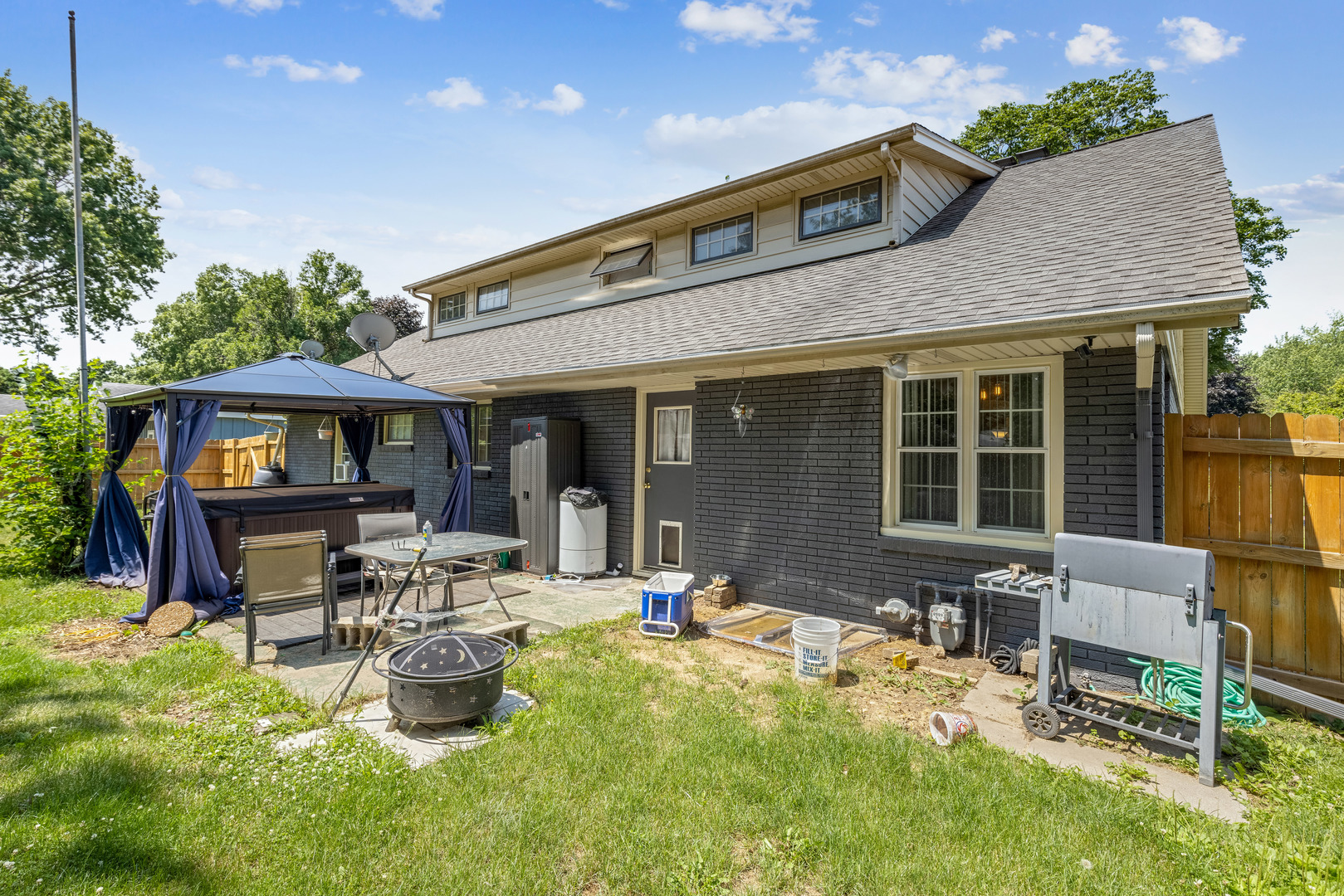 1229 Crest Lane Rochelle, IL 61068 - Photo 26 of 30 a front view of a house with sitting area and garden