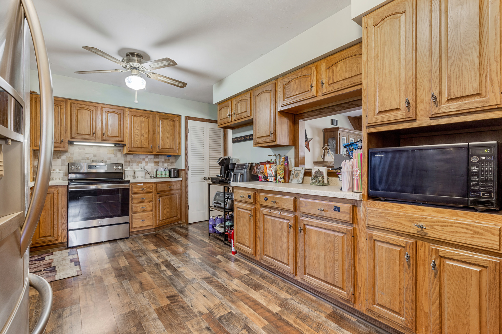 1229 Crest Lane Rochelle, IL 61068 - Photo 6 of 30 a kitchen with stainless steel appliances granite countertop a stove top oven a sink dishwasher and cabinets with wooden floor
