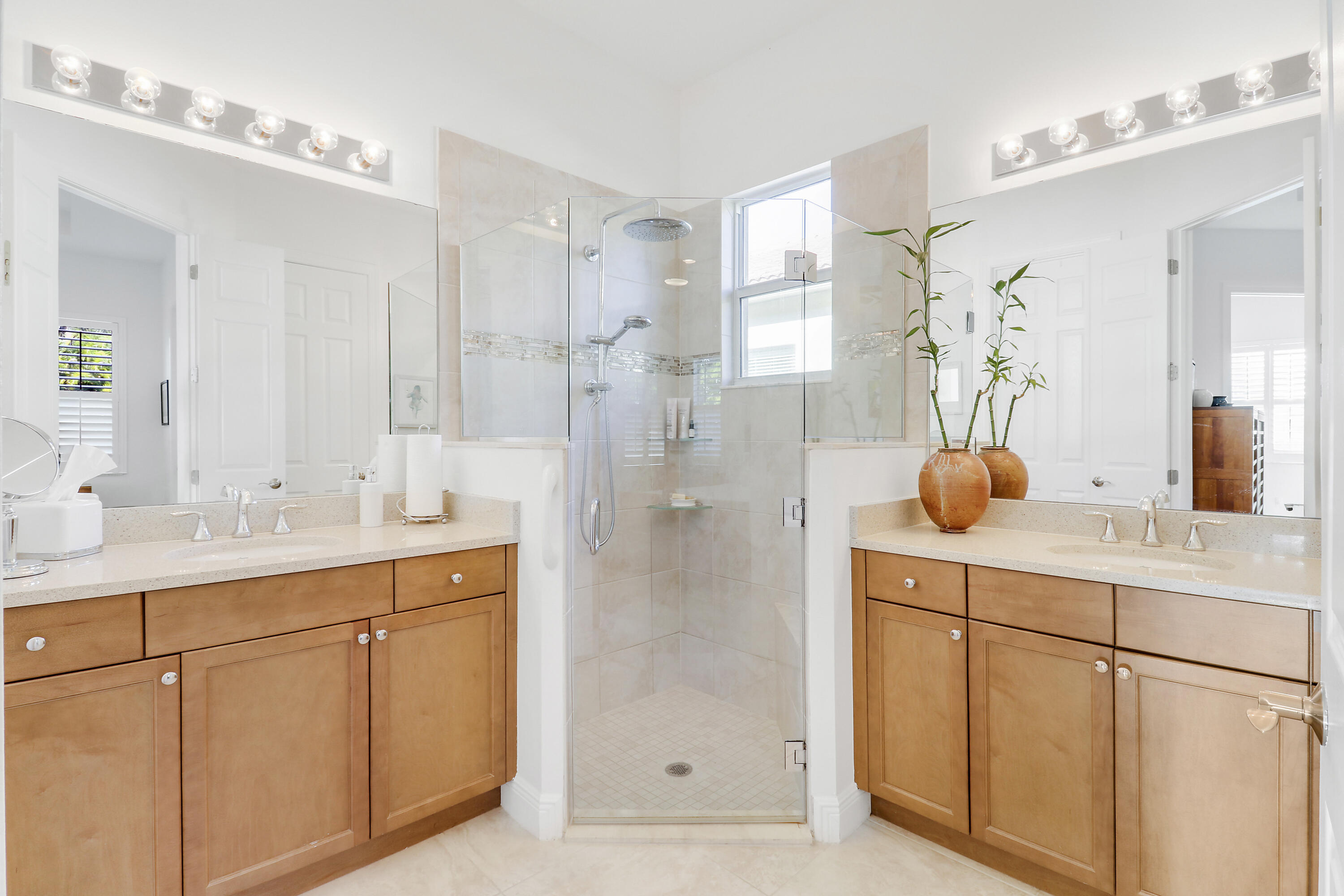 11215 Southwest Visconti Way Port St. Lucie, FL 34986 - Photo 19 of 61 a bathroom with a double vanity sink mirror and shower