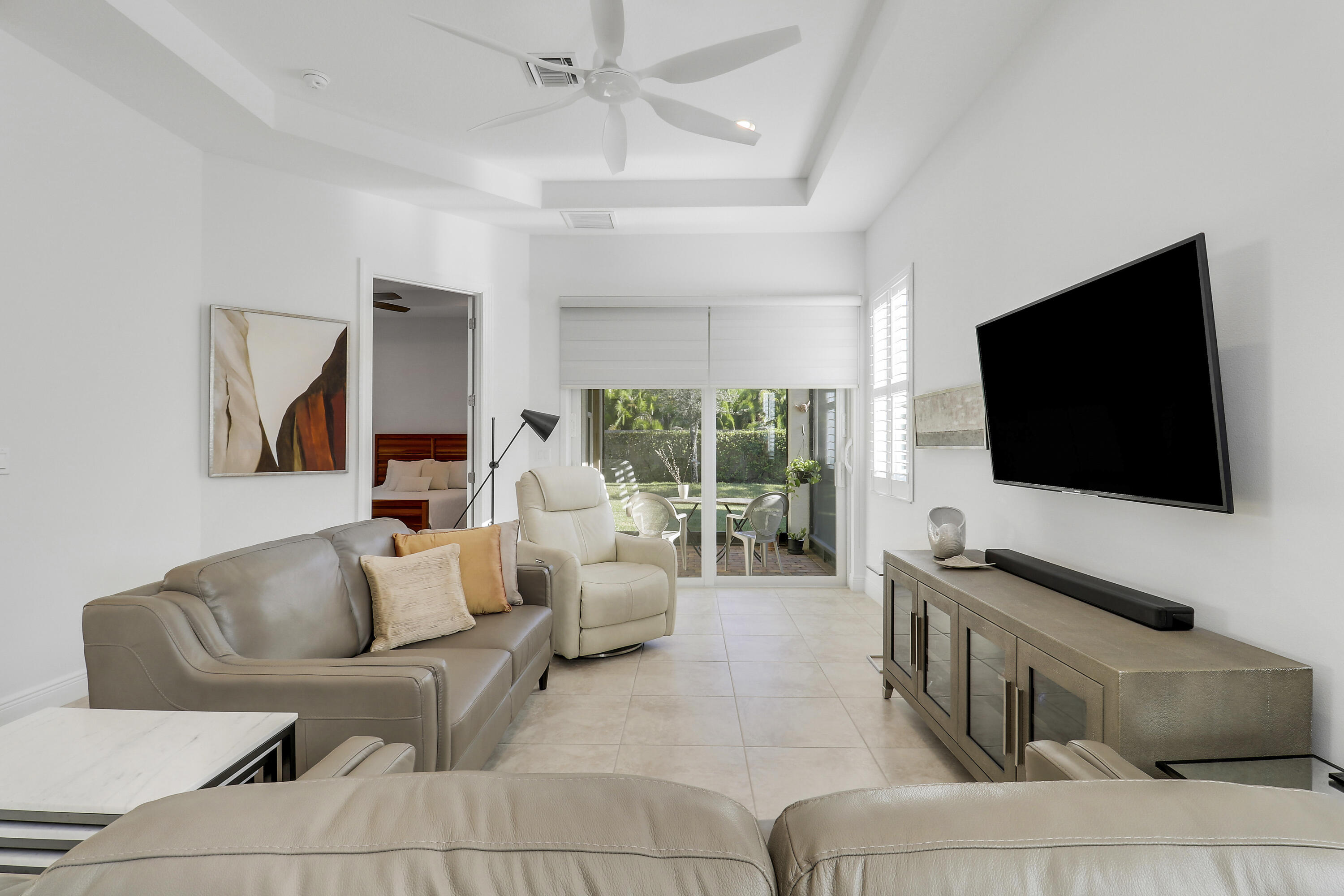 11215 Southwest Visconti Way Port St. Lucie, FL 34986 - Photo 8 of 61 a living room with furniture and a flat screen tv