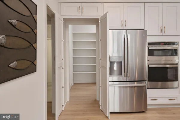 a kitchen with stainless steel appliances a refrigerator and a stove
