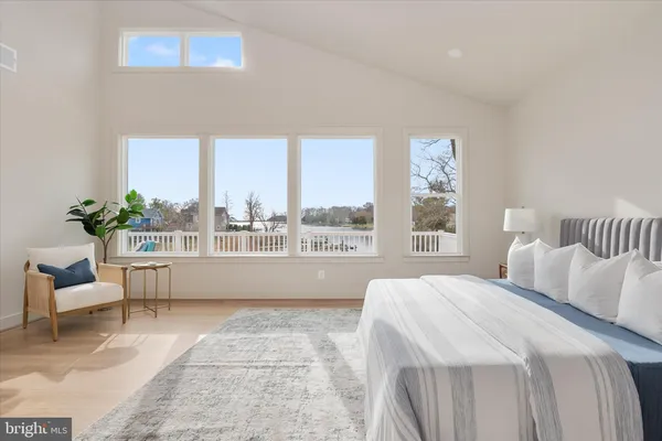 a spacious bedroom with a large window and a bed