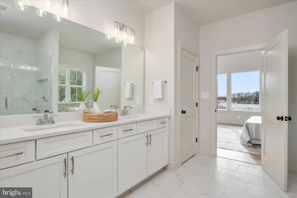 a spacious bathroom with a granite countertop sink mirror and toilet
