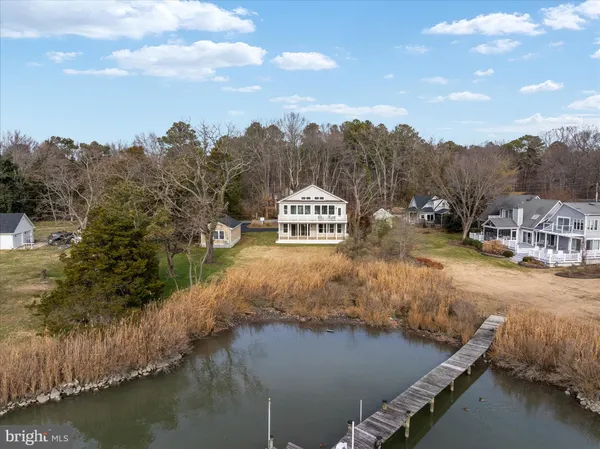a living room with fireplace furniture and a large window