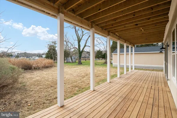 a view of a balcony with wooden floor