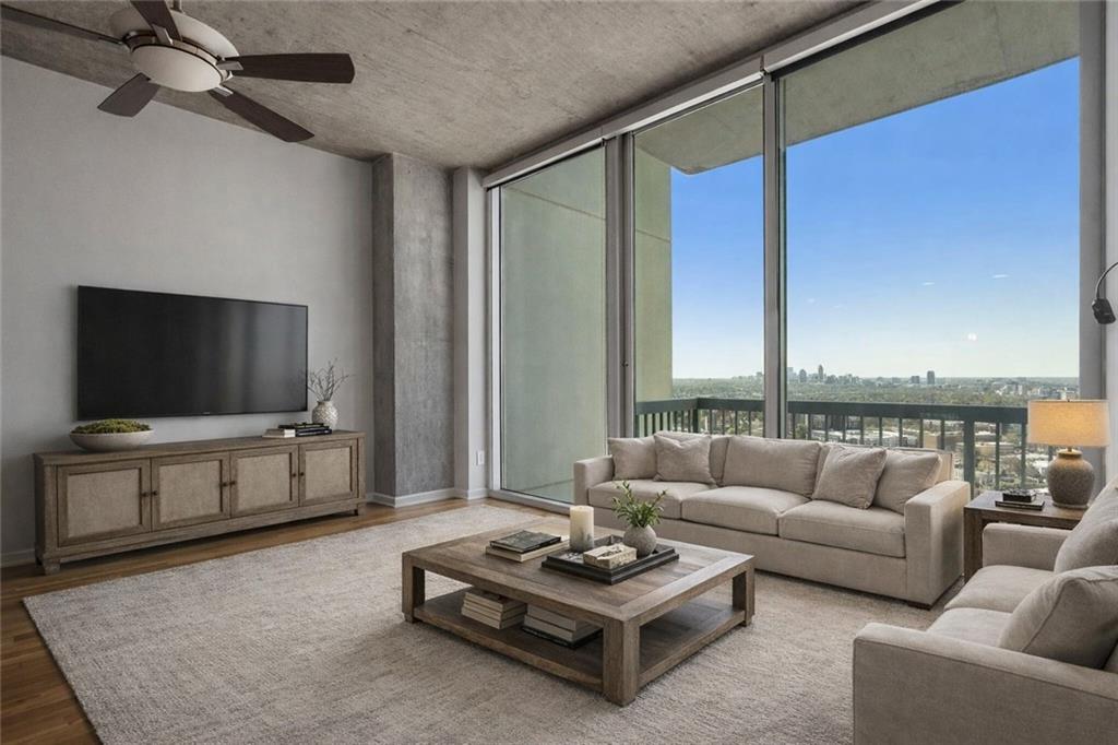 3324 Peachtree Road Northeast, Unit 2804 Atlanta, GA 30326 - Photo 3 of 34 a living room with furniture a flat screen tv and a large window