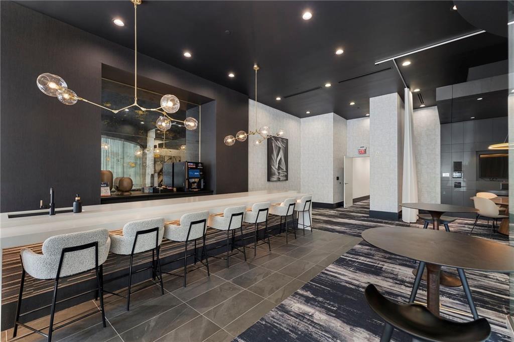 3324 Peachtree Road Northeast, Unit 2804 Atlanta, GA 30326 - Photo 31 of 32 a large kitchen with lots of counter space and dining table