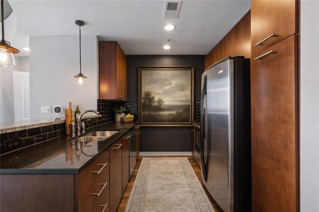 3324 Peachtree Road Northeast, Unit 2804 Atlanta, GA 30326 - Photo 5 of 34 a kitchen with a sink refrigerator and cabinets