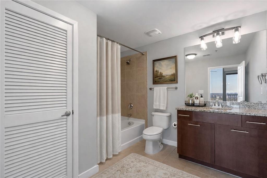 3324 Peachtree Road Northeast, Unit 2804 Atlanta, GA 30326 - Photo 8 of 34 a spacious bathroom with a toilet a sink and a mirror