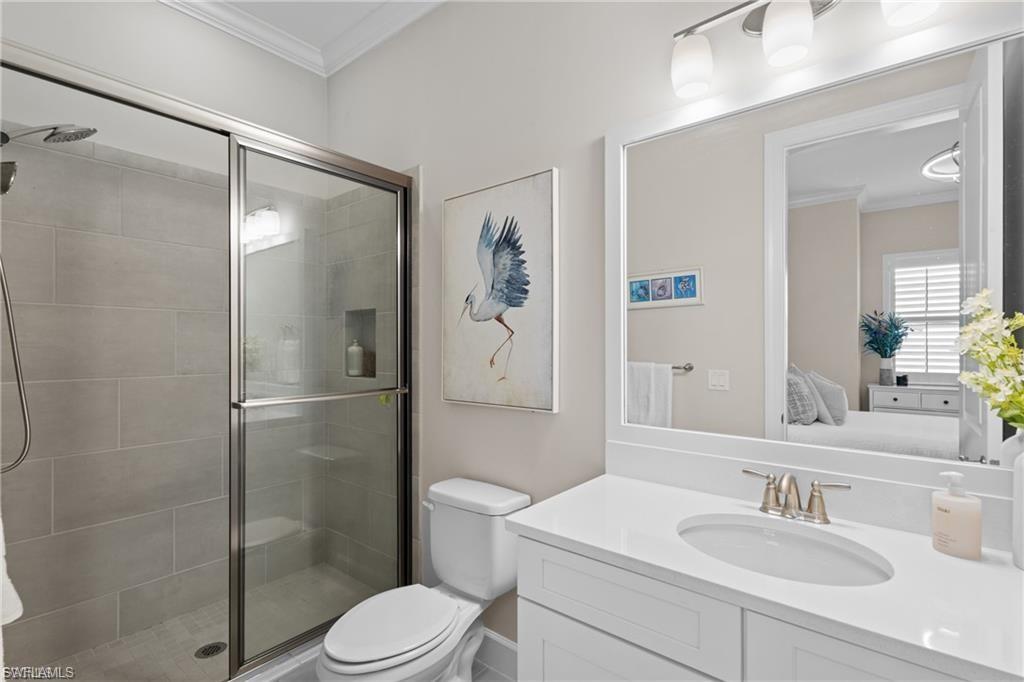 9642 Montelanico Loop, Unit 201 Naples, FL 34119 - Photo 16 of 27 a bathroom with a sink toilet and shower