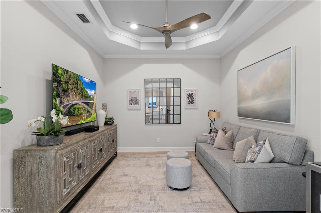 9642 Montelanico Loop, Unit 201 Naples, FL 34119 - Photo 19 of 27 a living room with furniture and a flat screen tv