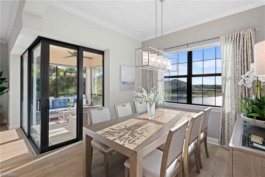 9642 Montelanico Loop, Unit 201 Naples, FL 34119 - Photo 20 of 27 a view of a dining room with furniture window and wooden floor