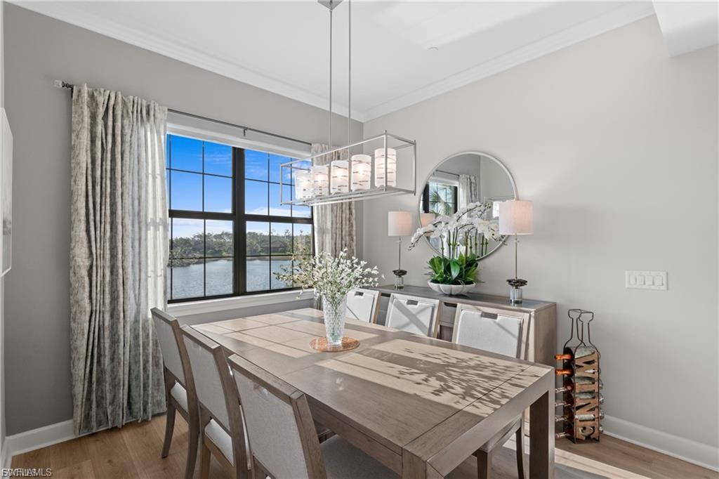 9642 Montelanico Loop, Unit 201 Naples, FL 34119 - Photo 21 of 27 a dining room with furniture a chandelier and window