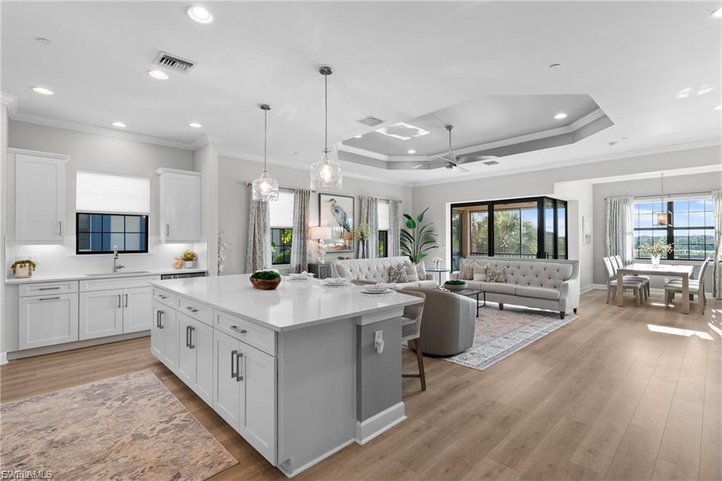9642 Montelanico Loop, Unit 201 Naples, FL 34119 - Photo 23 of 27 a kitchen with sink stove and cabinets