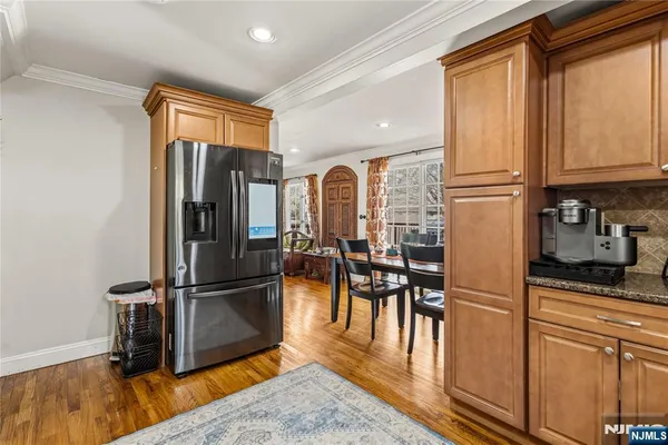 a kitchen with stainless steel appliances granite countertop a refrigerator and microwave