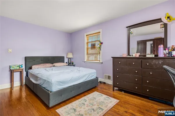 a bedroom with a bed and a dresser