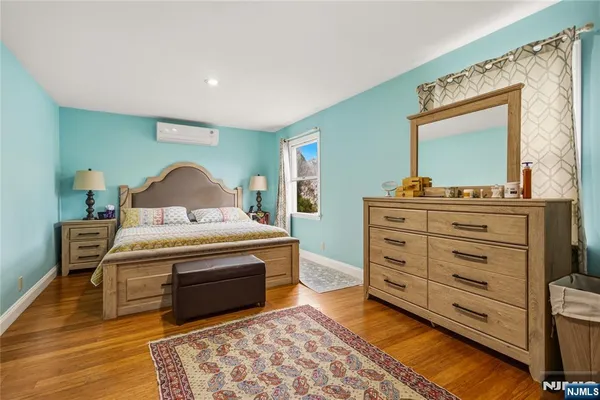 a living room with furniture and a dresser