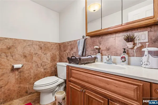 a bathroom with a sink a toilet and mirror