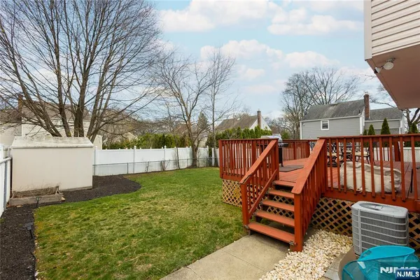 a backyard of a house with barbeque oven and outdoor seating