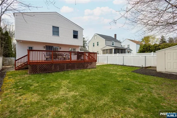 a view of a house with a backyard and a yard