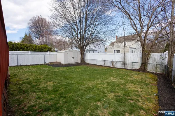 a view of a backyard with a large tree