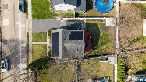 an aerial view of a house with pool and outdoor seating