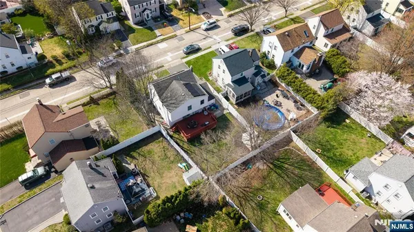an aerial view of a house a yard and outdoor seating