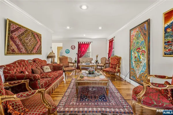 a living room with furniture a rug and a painting on the wall