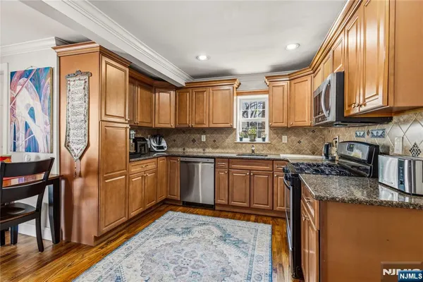a kitchen with stainless steel appliances granite countertop a refrigerator sink and cabinets
