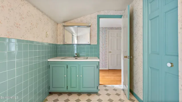 a view of a big room with wooden floor and windows
